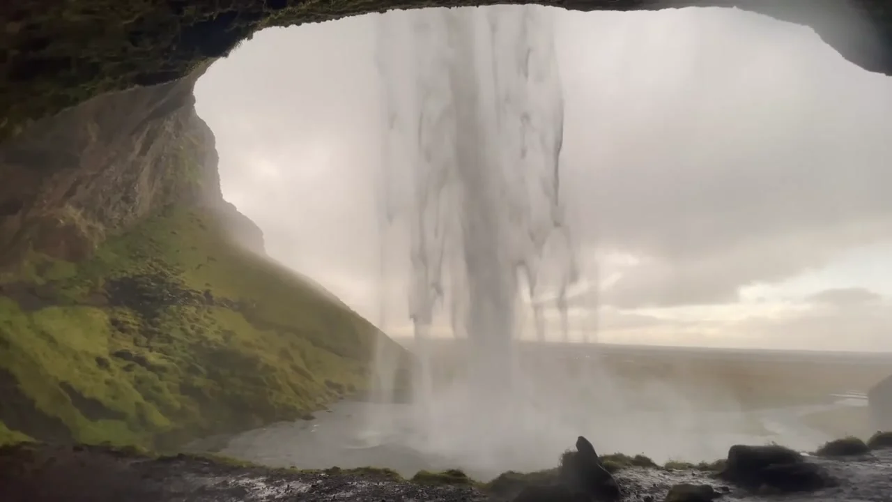 Vista desde dentro de la cascada Seljalandsfoss al pasar por detrás, sur de Islandia