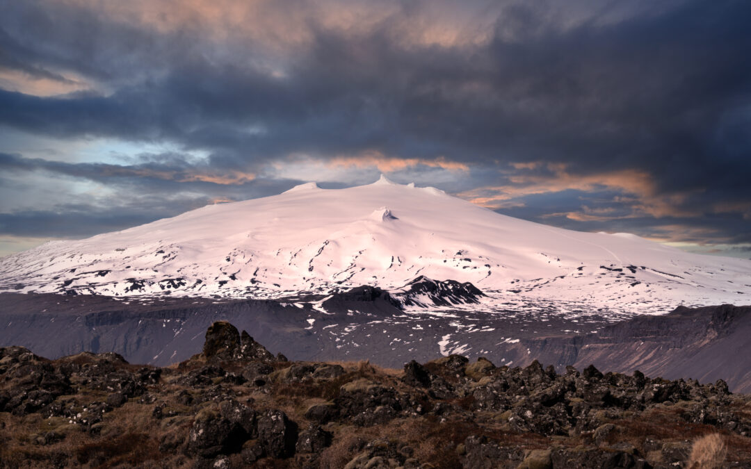Vista panorámica del glaciar Snæfellsjökull con espectaculares nubes de atardecer y colores cálidos sobre la península de Snæfellsnes, Islandia